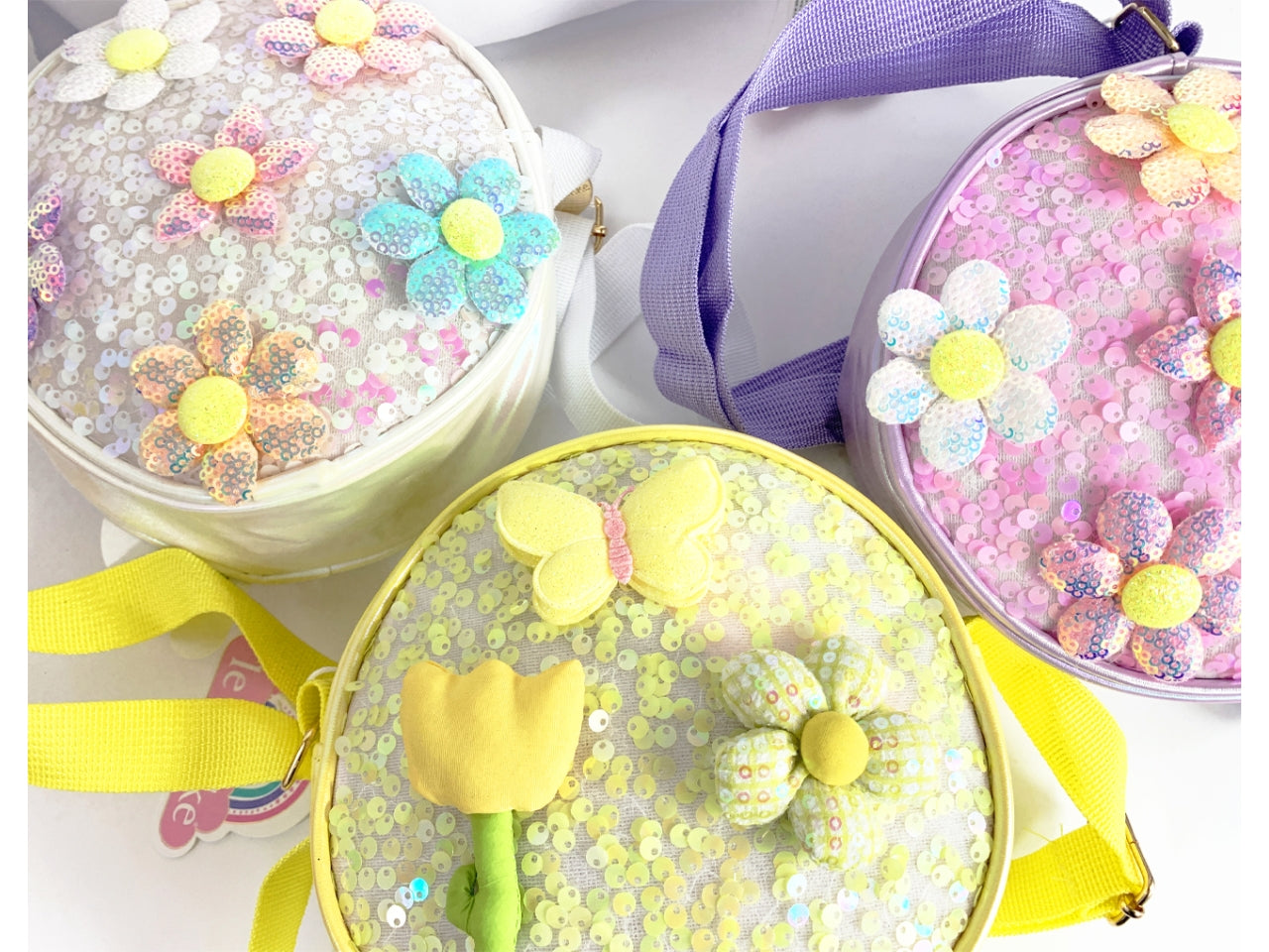 Borsetta bimba flowers BK10055 in 3 colori assortiti in tessuto sintetico paiettato, 17cm di diametro - Le Kikke